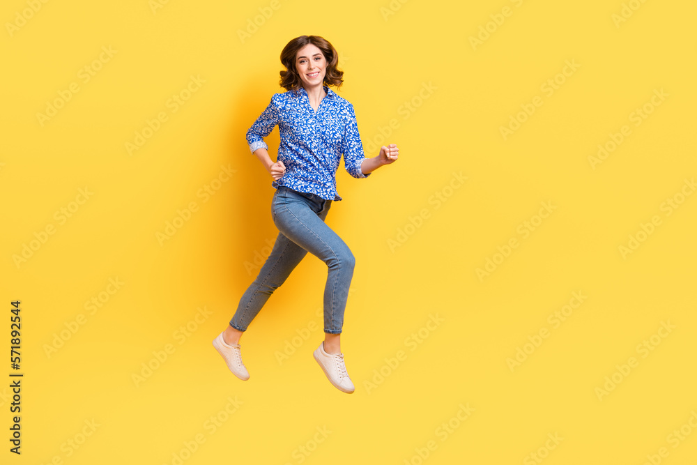 Full length profile photo of active sportive person running rush jumping isolated on yellow color background