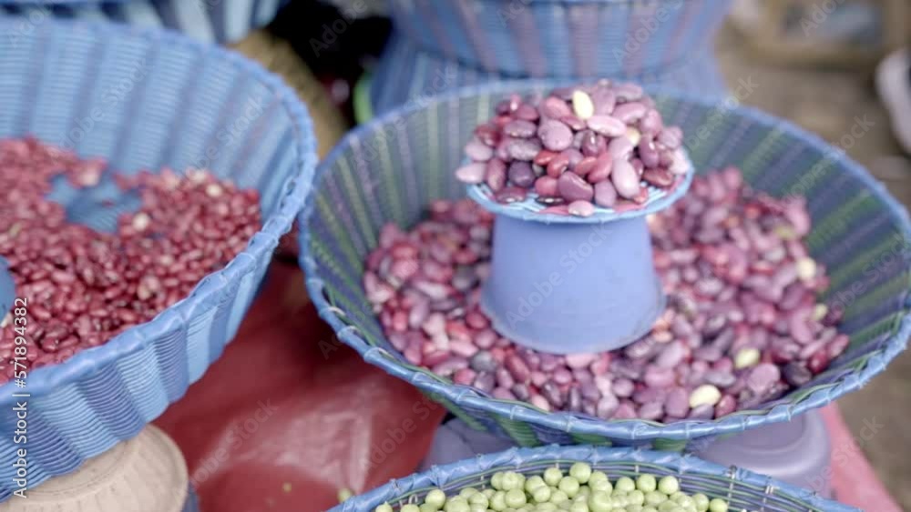 Some purple and red beans are being displayed a Mexican street market stall Some purple and red beans are being displayed a Mexican street market stall