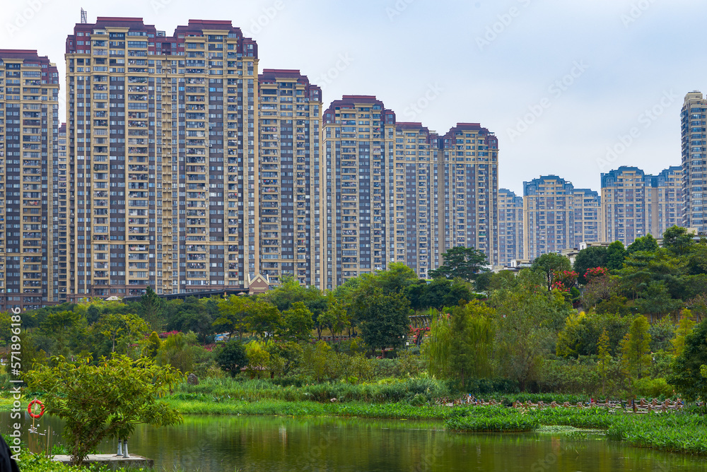 Harmonious landscape of city lake green park and high rise residential buildings