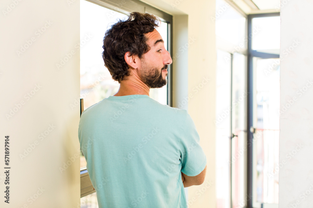 young adult crazy man with expressive pose at a modern house interior young adult crazy man with expressive pose at a modern house interior