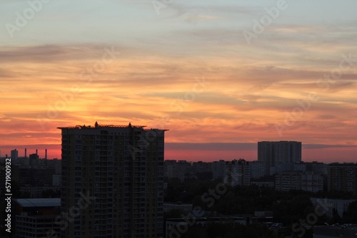 Colorful cloudy twilight beautiful sky cityscape sunset and morning sunrise. Dramatic evening night early morning view with city buildings silhouette. Panoramic background concept. Copy space for text