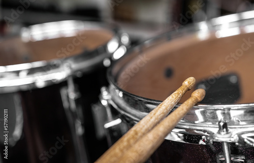 Drumsticks and drums for live music rock perfomance closeup. Wooden musical sticks for percussion instruments