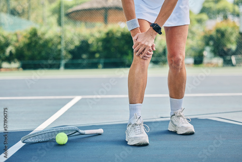 Fototapeta Naklejka Na Ścianę i Meble -  Tennis court, woman knee injury and training outdoor for fitness, health or wellness by blurred background. Summer, sports and exercise with pain in legs at game, contest or competition in sunshine