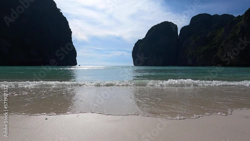 Waves in the withe sand of empty Maya Bay beach in Thailand