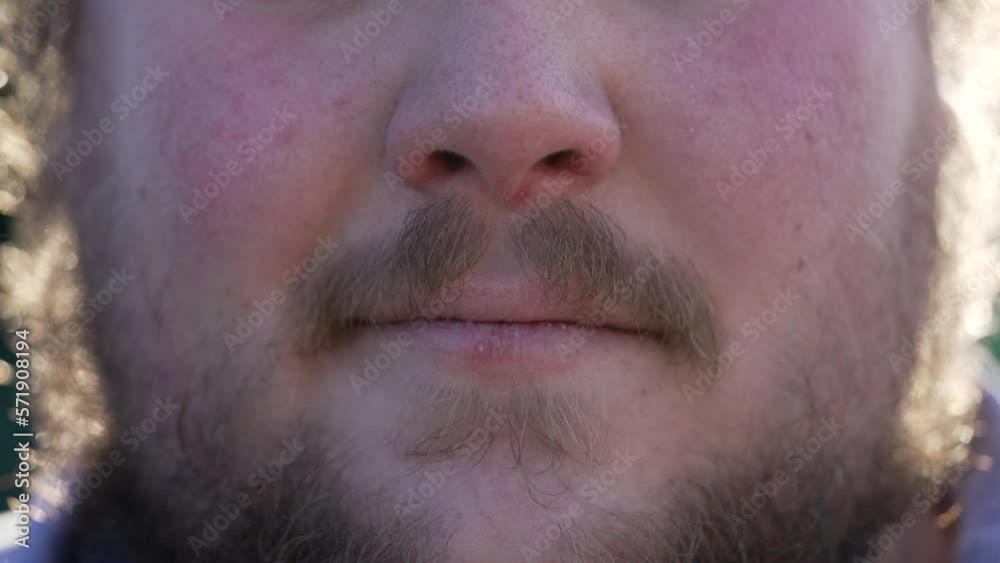 Grumpy Young man mouth close up becoming angry and upset. Change of emotion lips detail Grumpy Young man mouth close up becoming angry and upset. Change of emotion lips detail