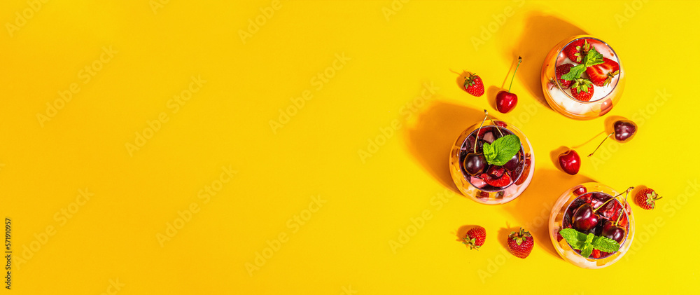 Delicious Italian dessert panna cotta with sweet cherry sauce, strawberry jam, fresh berries, mint