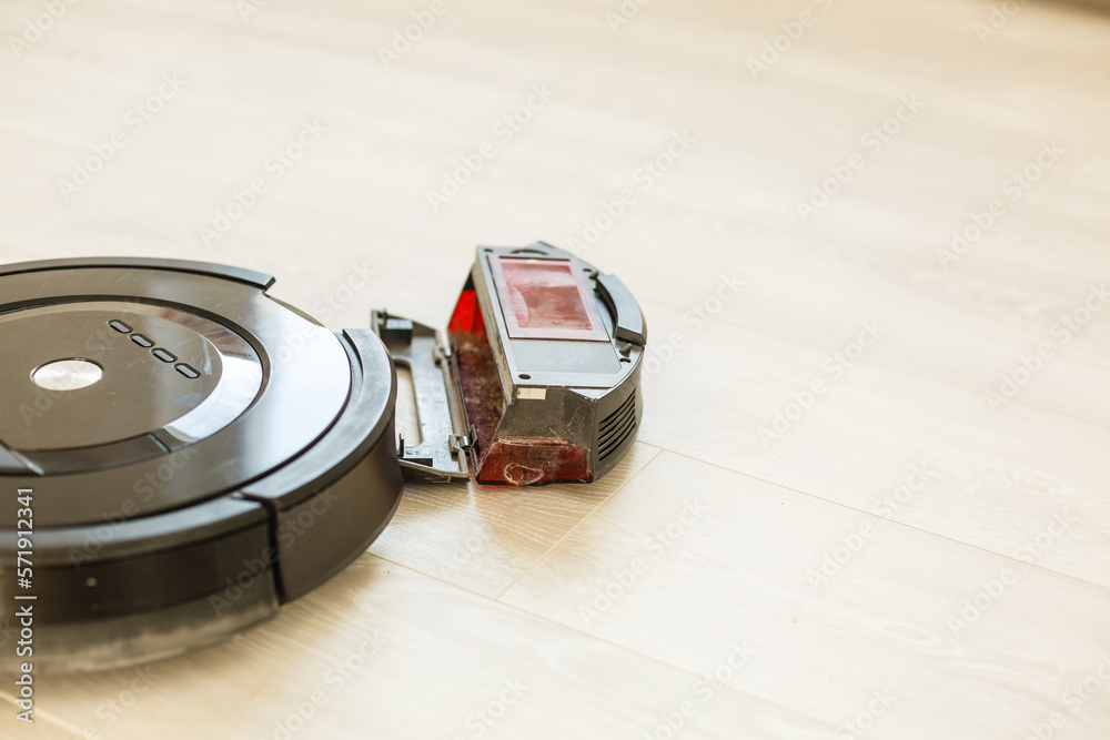 Repair and maintenance of robot vacuum cleaners. Disassembled vacuum cleaner  for soldering the chip. A broken robot vacuum cleaner. Stock Photo | Adobe  Stock