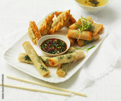 Chinese snacks - spring rolls and fried gyoza photo