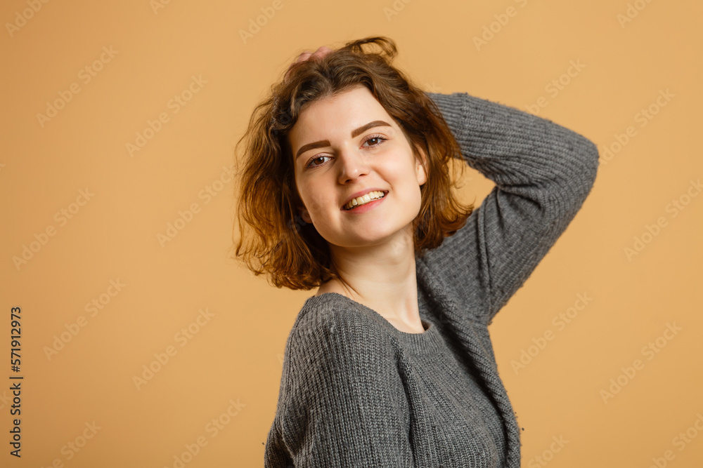 Obraz premium Close up portrait of young happy woman on beige background