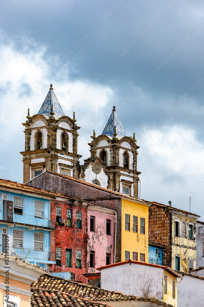 Historic baroque church towers rising between old colorful houses in the Pelourinho neighborhood in the city of Salvador, Bahia