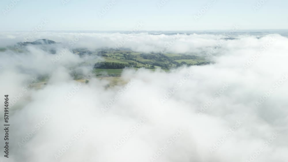 Flying above the clouds over beautiful forest and green fields below. Aerial. Drone. 4K. Flying above the clouds over beautiful forest and green fields below. Aerial. Drone. 4K.