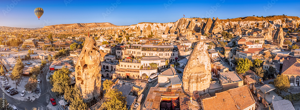 Obraz premium Aerial view of Air Balloon and hotels and houses of soft volcanic tuff in Cappadocia - one of the wonders of the world in Turkey.