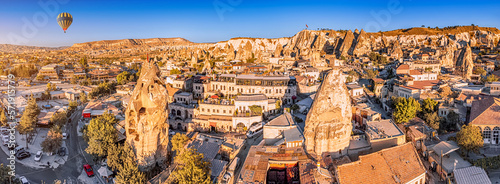 Aerial view of Air Balloon and hotels and houses of soft volcanic tuff in Cappadocia - one of the wonders of the world in Turkey.