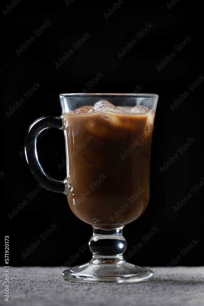 Preparation of cold coffee. Coffee and milk are poured into a glass with ice