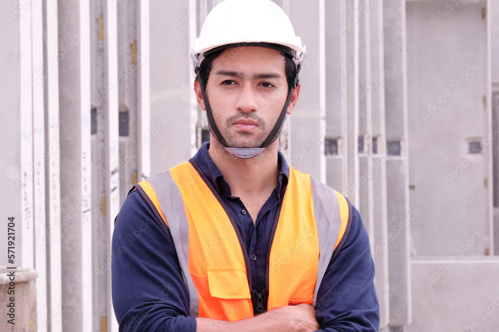 Engineer in safety helmet standing smiling at job site. Engineer concept. Engineer in safety helmet standing smiling at job site. Engineer concept.