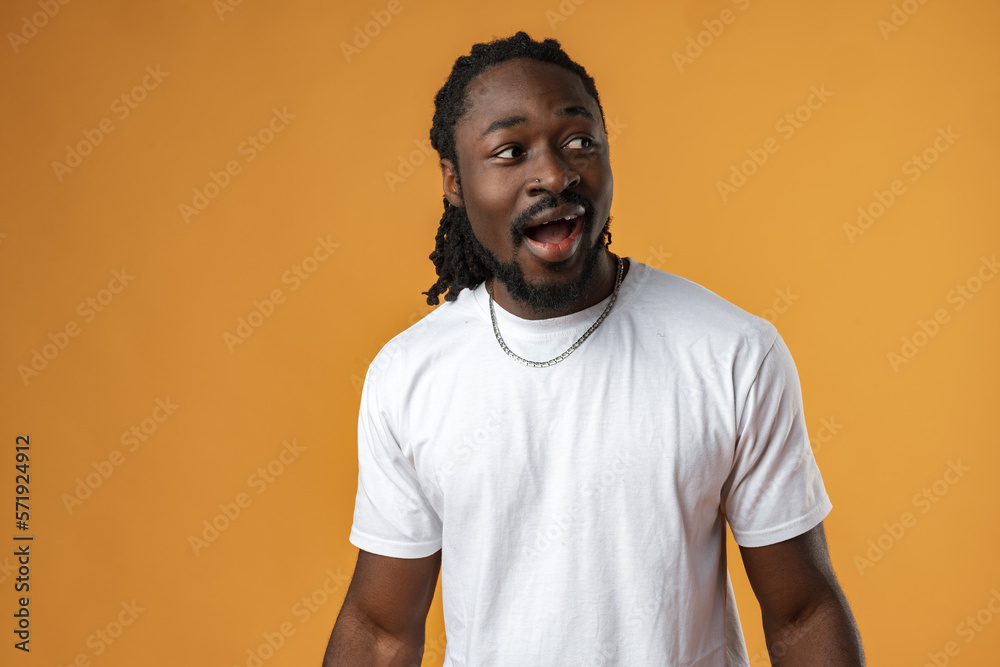 Handsome smiling young african man standing isolated over yellow background Handsome smiling young african man standing isolated over yellow background
