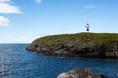 Beautiful natural landscape of Norway with a lighthouse. Scenic outdoor view. Ocean with waves and mountains. Explore Norway, Lofoten Islands