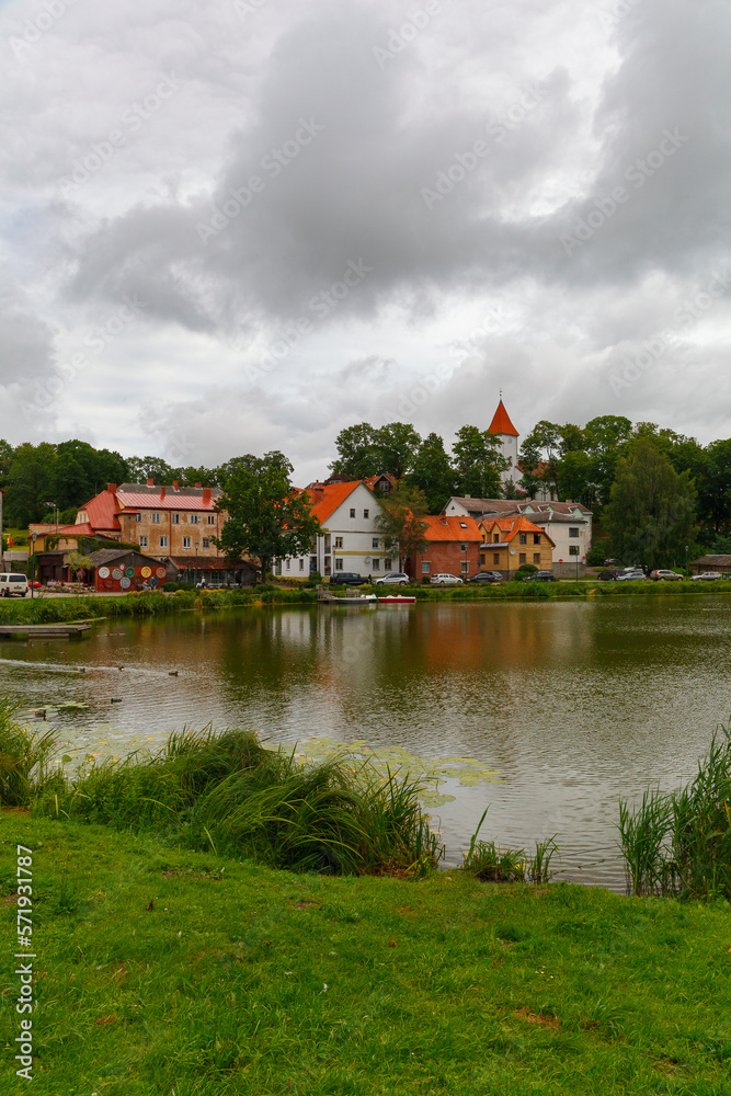 TALSI, LATVIA, SEPTEMBER 10, 2022: Colorful old town houses and church with lake reflection in Talsi Latvia.