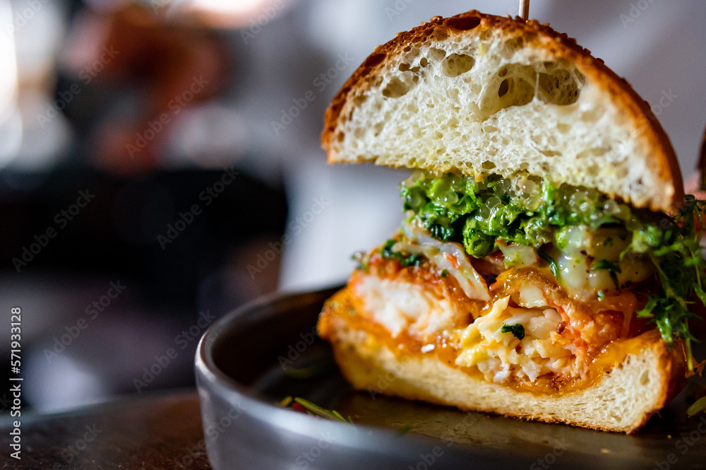 half seafood burger with shrimps, crab, caviar, cheese and vegetables half seafood burger with shrimps, crab, caviar, cheese and vegetables