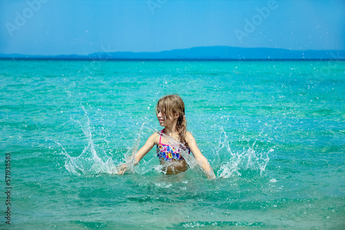 happy child at sea in greece plays in nature © Kostia