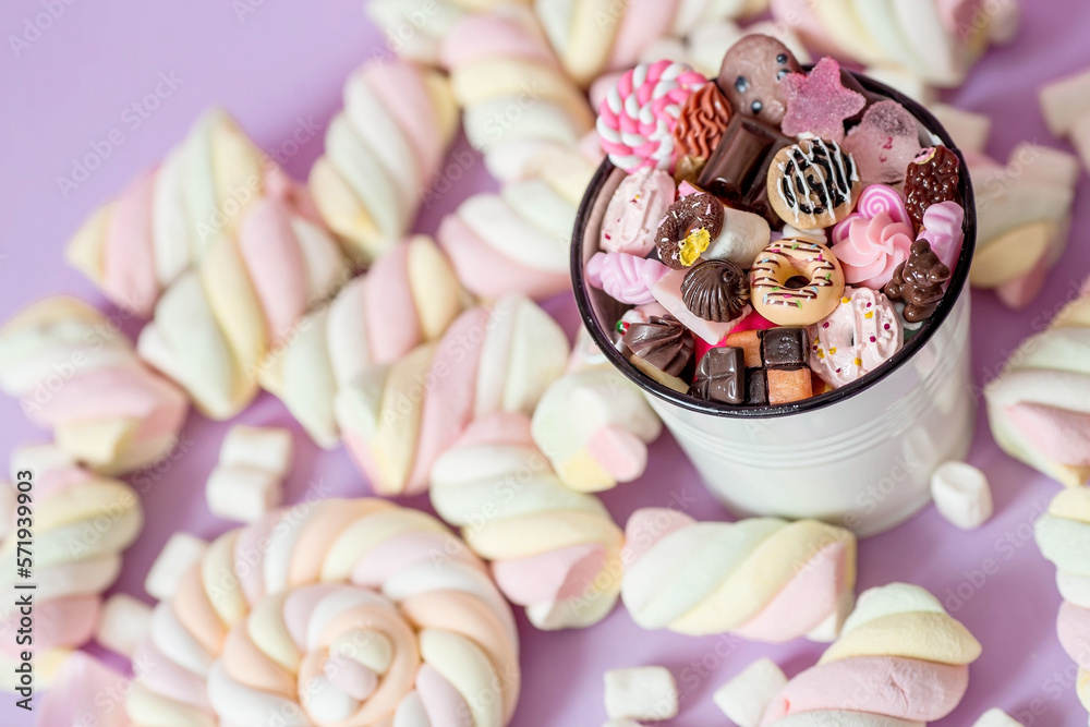 Marshmallows. Chewing candy close-up on a pink background. Dessert of sweet dishes in a white bucket. Pastel colors. A copy of the text space. Marshmallows. Chewing candy close-up on a pink background. Dessert of sweet dishes in a white bucket. Pastel colors. A copy of the text space.