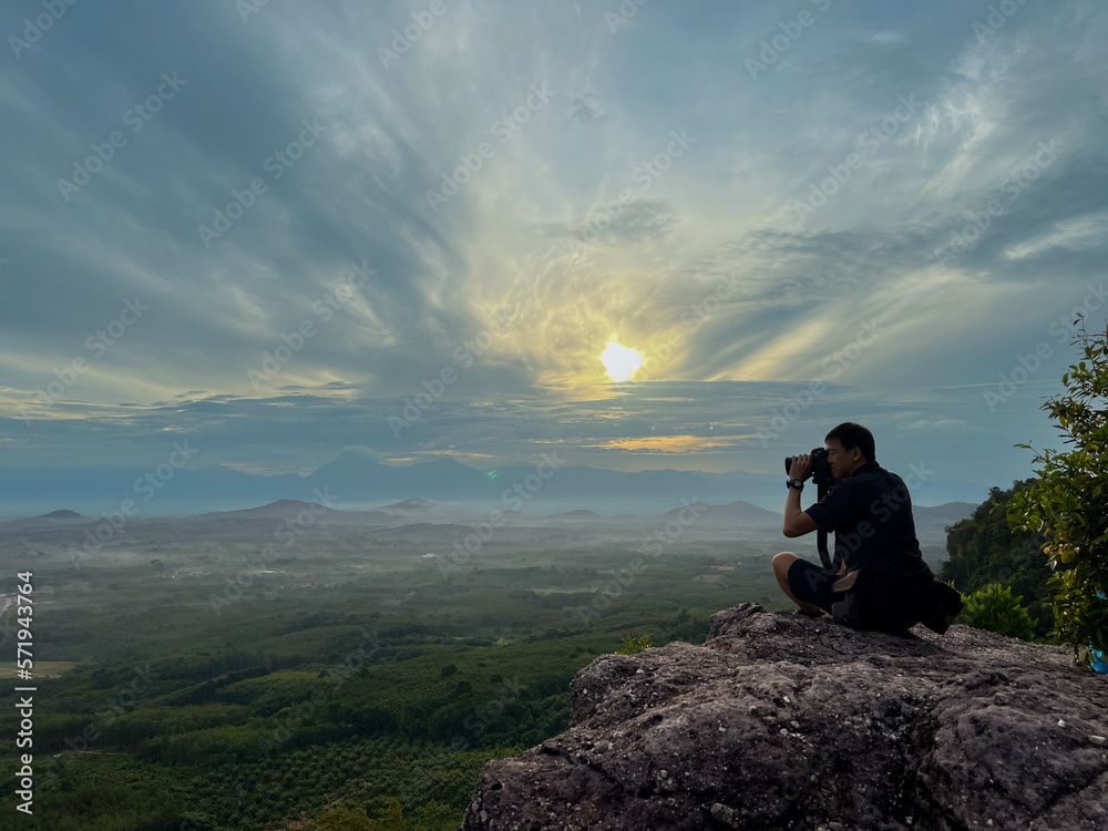 The photographer sits and looks at the sea of clouds. in Nakhon Si Thammarat Province