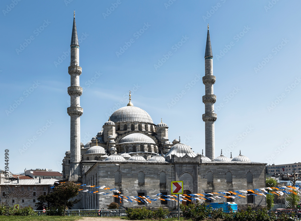 Tourists and residents near the New mosque, or Valide Sultan Mosque in Istanbul, Turkey