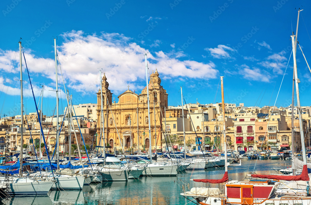 Fototapeta premium View of marina boats and catholic church in Msida. Valletta, Malta