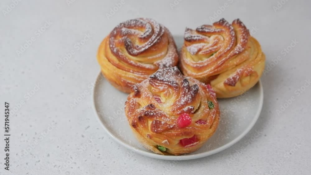 Craffin mini (Cruffin) with raisins and candied fruits. Traditional Easter Bread Kulich. Easter Holiday. Close-up, selective focus. Craffin mini (Cruffin) with raisins and candied fruits. Traditional Easter Bread Kulich. Easter Holiday. Close-up, selective focus.