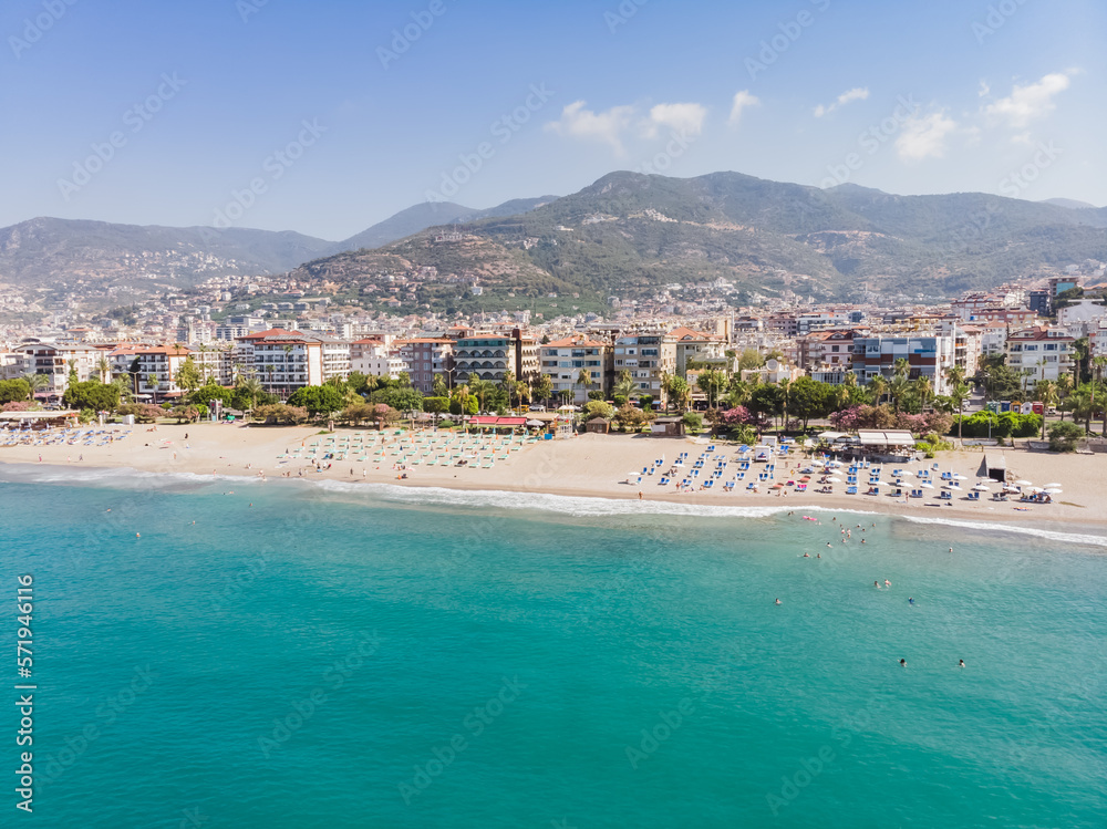 Top view of the tourist city of Alanya located between the mountains and the sea in Turkey, on a sunny summer day