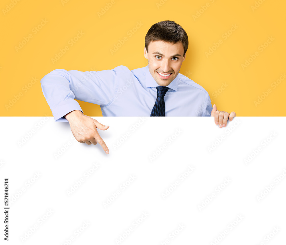Portrait image of business man professional bank manager in confident cloth. Businessman stand behind, hang over, show point finger empty white banner signboard. Isolated orange yellow background Portrait image of business man professional bank manager in confident cloth. Businessman stand behind, hang over, show point finger empty white banner signboard. Isolated orange yellow background