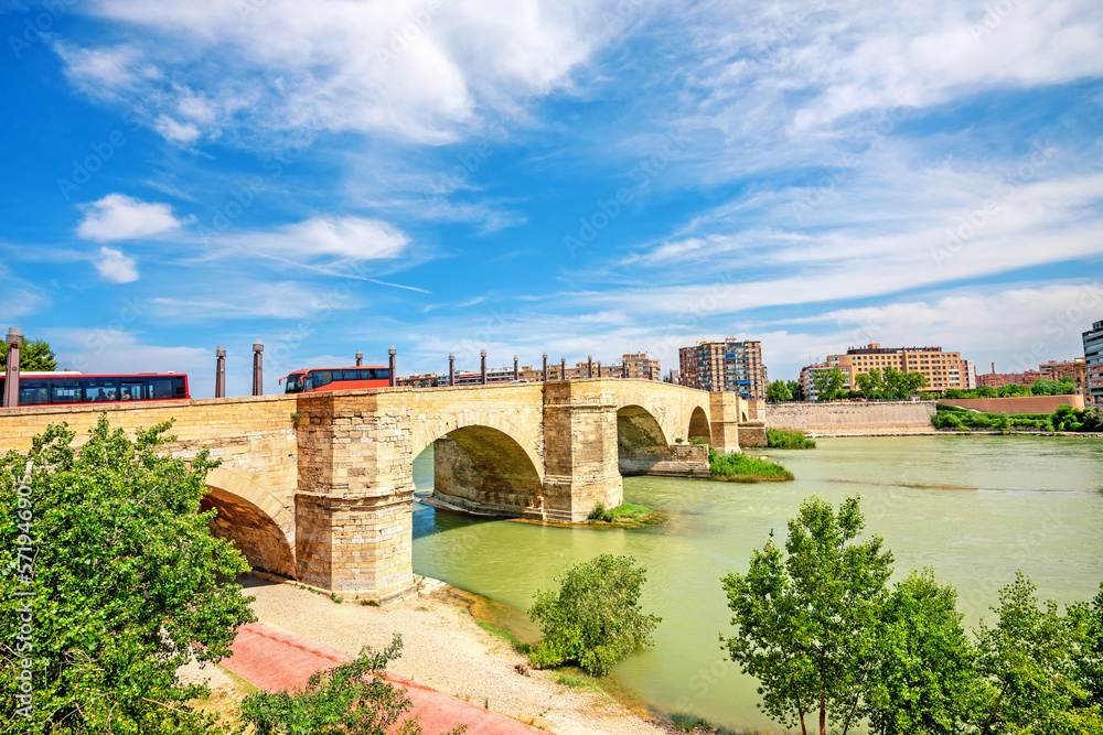 Landscape with arch stone bridge on river Ebro in Zaragoza. Aragon, Spain
