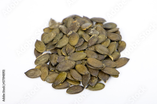 pumpkin seeds on white background, closeup of photo, selective focus
