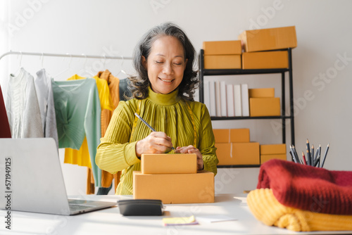 Elderly Asian business woman home office SMEs owner of online clothing store. and fashion designer, social media influencer