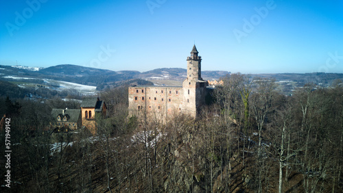 Aerial top view of Grodno castle in Zagorze in Owl Mountains with beautiful winter landscape. Old historical fortress in mountains, covered with forest. 