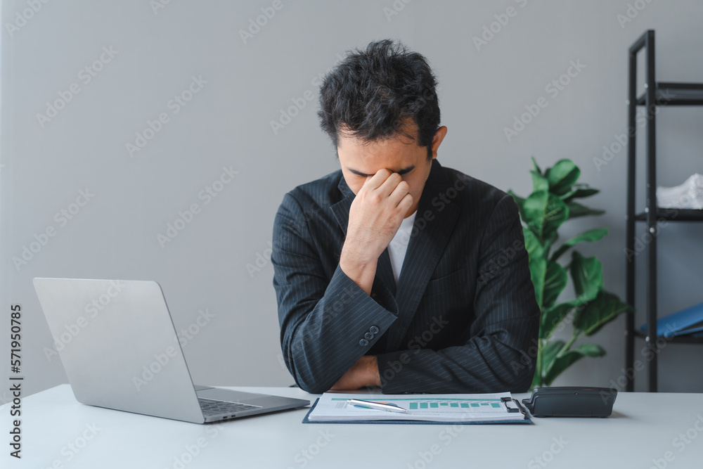 Young handsome asia business man in formal suit working with monthly report balance sheet and yearly tax of accounting to verify the account by an authorized auditor Young handsome asia business man in formal suit working with monthly report balance sheet and yearly tax of accounting to verify the account by an authorized auditor