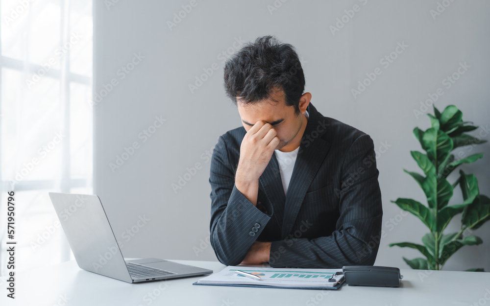 Young handsome asia business man in formal suit working with monthly report balance sheet and yearly tax of accounting to verify the account by an authorized auditor Young handsome asia business man in formal suit working with monthly report balance sheet and yearly tax of accounting to verify the account by an authorized auditor