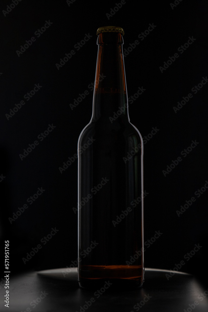 A bottle of beer on a black background