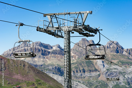 Chair lift of the Astun ski resort in summer and Lakes of Astun hike in Aragon pyrenees mountains in a suuny day photo