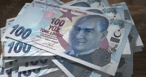Turkish Lira 100 TRY banknotes falling on the table. Turkey currency paper notes count on stack. Timelapse of money counting. 3D concept.