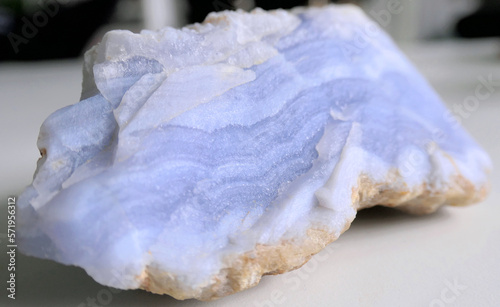 Piece of natural raw blue lace agate crystal with beautiful violet stripes