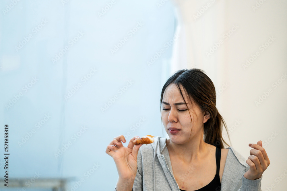 slim woman finishing bad chocolate croissant. gorgeous healthy woman lost control to unhealthy sweets deciding not to do balance workout. asian beautiful woman gain weight eating chocolate croissant slim woman finishing bad chocolate croissant. gorgeous healthy woman lost control to unhealthy sweets deciding not to do balance workout. asian beautiful woman gain weight eating chocolate croissant