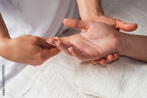 Masseur doing hand massage with oil in spa salon. Spa procedures. Body care concept. Close-up view