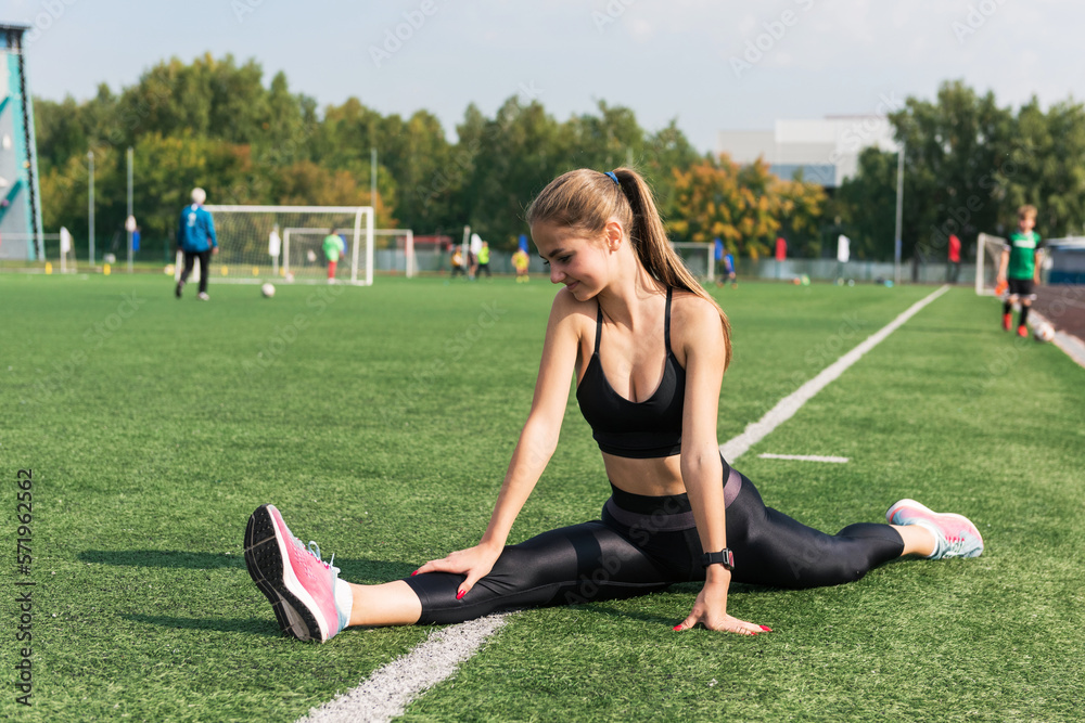 Young woman athlete is exercising at the stadium outdoors Young woman athlete is exercising at the stadium outdoors