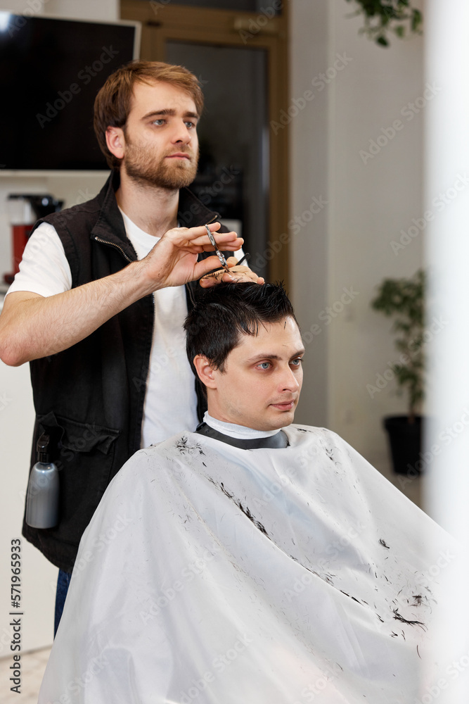 hairdresser does haircut for caucasian bearded man hairdresser does haircut for caucasian bearded man