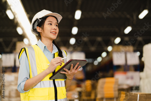 Portrait of Asian woman warehouse supervisor working distribution warehouse to managing inventory and logistics.