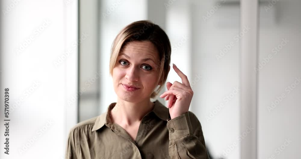 Portrait of young office woman smiling and showing gesture to think Portrait of young office woman smiling and showing gesture to think