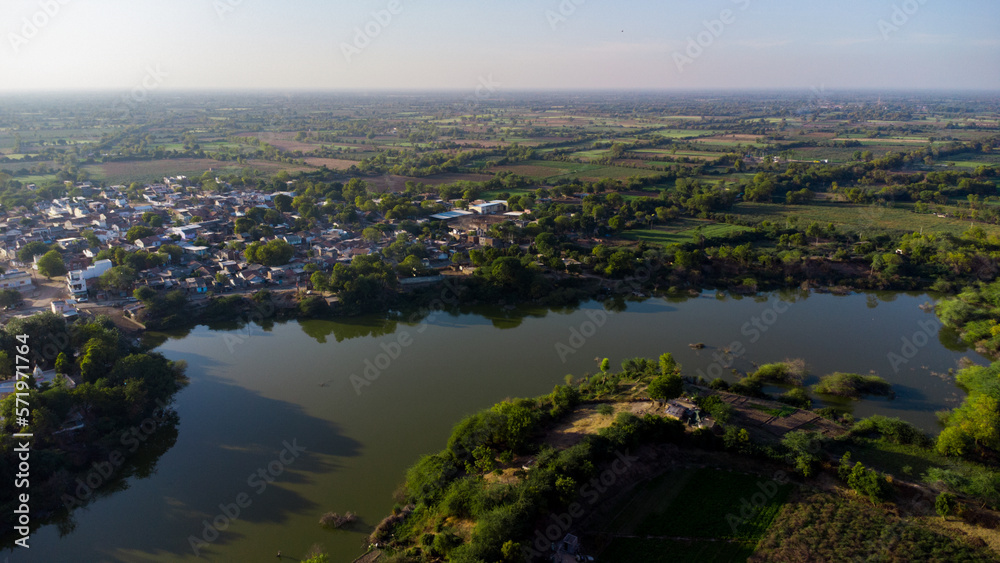Aerial drone photography of urban rural houses green village near water lake river pond sky top view