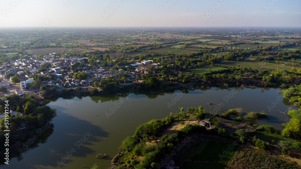 Aerial drone photography of urban rural houses green village near water lake river pond sky top view Aerial drone photography of urban rural houses green village near water lake river pond sky top view