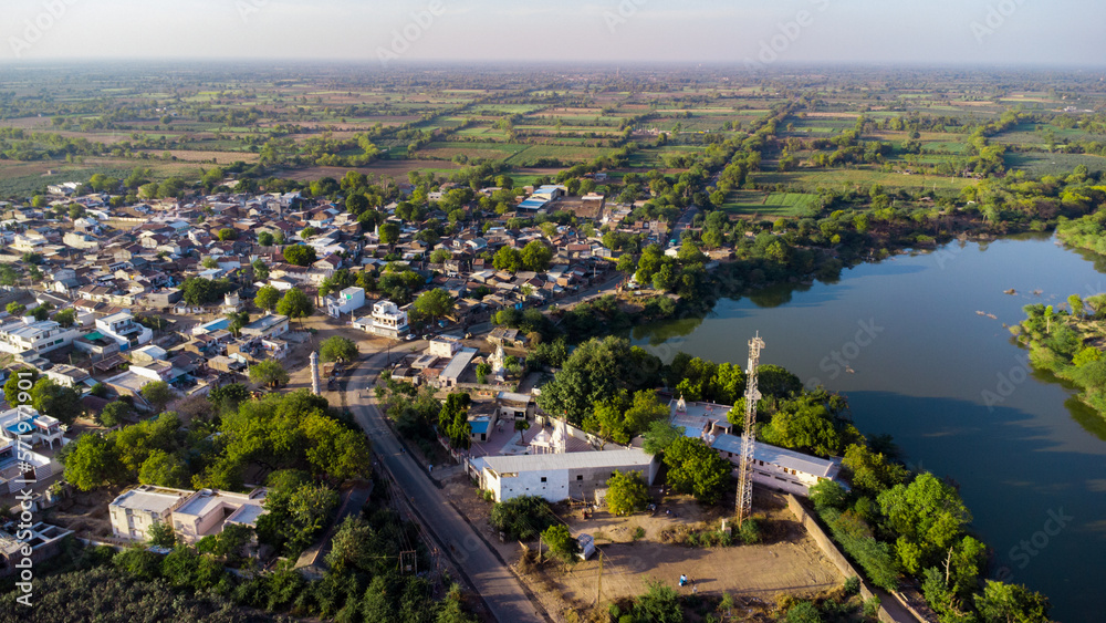 Aerial drone photography of urban rural houses green village near water lake river pond sky top view